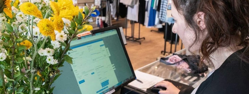 Woman working the register at The Closet Trading Company