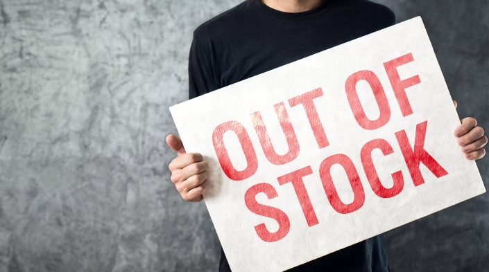 Person holding up out of stock sign