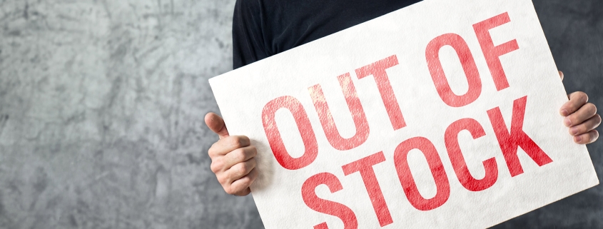 Person holding up out of stock sign