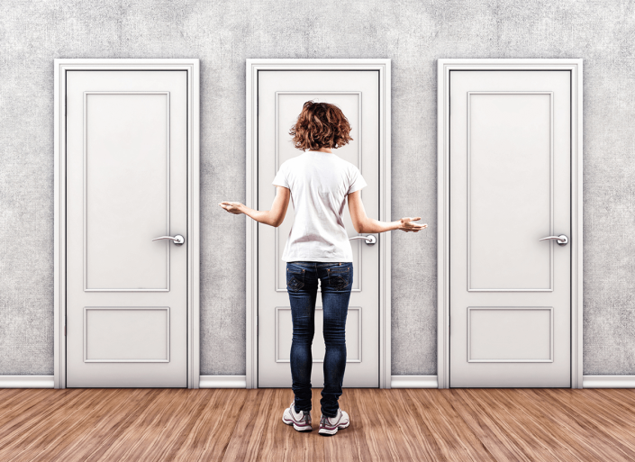 Woman deciding between 3 doors to walk through