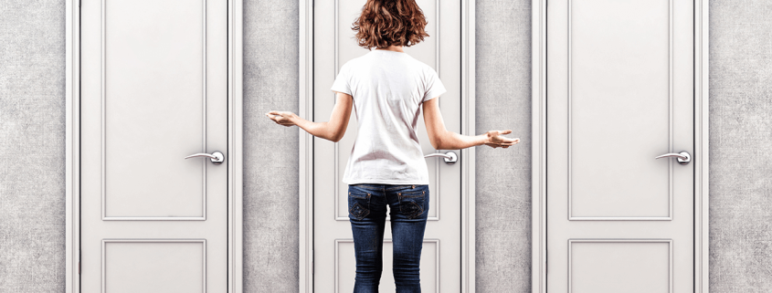 Woman deciding between 3 doors to walk through